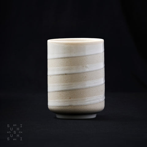 White Ceramic Spiral Cup on Black Background